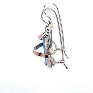 May include: Silver and copper dangle earrings with a blue and white stone. The earrings have a hook closure.