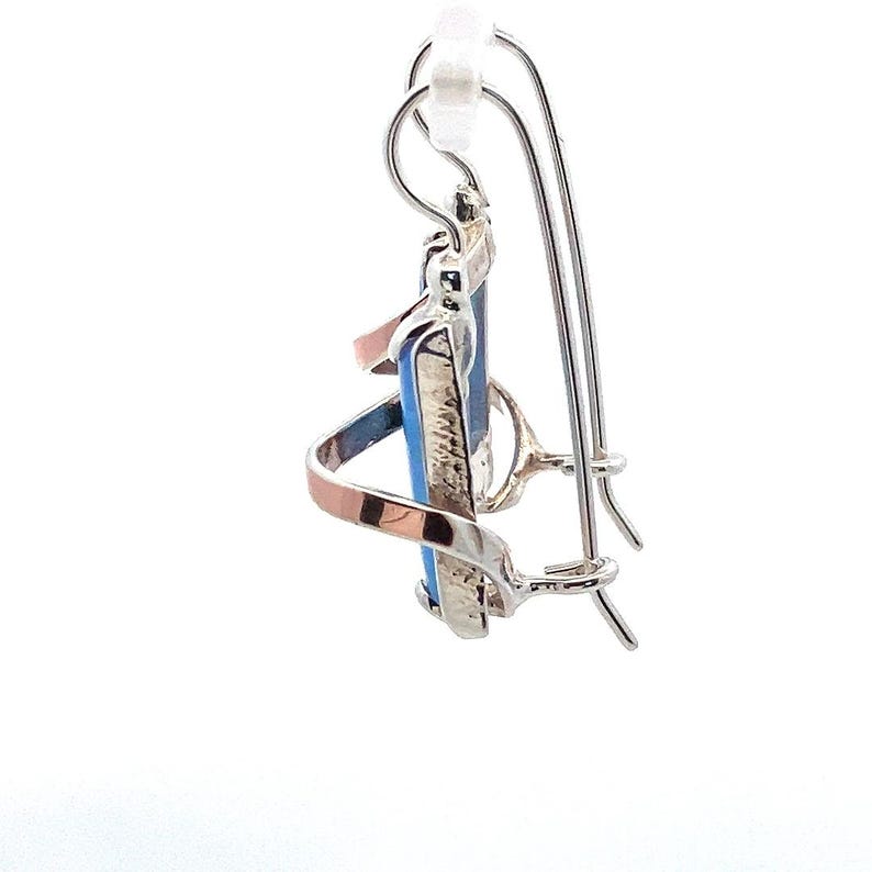 May include: Silver and copper dangle earrings with a blue and white stone. The earrings have a hook closure.