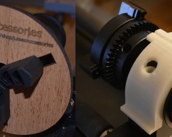 May include: A close-up of a black and white 3D printed laser engraving rotary. The rotary has a gear and a white plastic ring with a hole in it. The text "LaserAccessories" and a website address are printed on a wooden base.