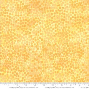 May include: Yellow fabric with a scattered pattern of small, orange circles.