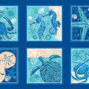 May include: A blue fabric panel featuring six square illustrations of marine life. The images include a crab, seahorses, a starfish, sand dollars, a sea turtle, and an octopus. The panel has a dark blue background with light blue borders.