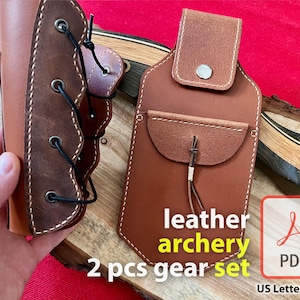 May include: A two-piece leather archery gear set. The set includes a brown leather arm guard with a lace-up design and a brown leather quiver with a flap and a small pocket. The text "leather archery 2 pcs gear set" is printed in yellow on a wooden surface.