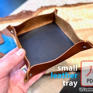 May include: A small brown leather tray with a black felt lining. The tray is being held in a hand. The text "small leather tray" is printed below the tray. A PDF icon is below the text with the words "US Letter & A4" below the icon.