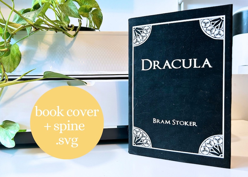 May include: A black book cover with the title "Dracula" and the author "Bram Stoker" in white text. The cover has a decorative design in white.