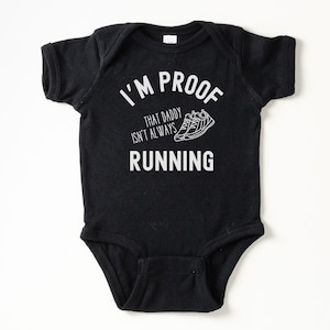 May include: Black bodysuit with white text that reads "I'm proof that daddy isn't always running" with a graphic of two running shoes.