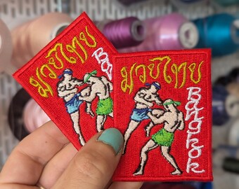 Embroidered patch, souvenir of the Muoy Thai fight in Bangkok, Thailand. Sew-on or iron-on. 7 cm x 5.5 cm. Custom design. Price per unit.