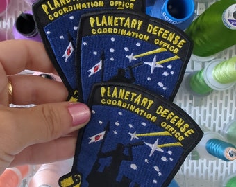 Parche bordado Defensa Planetaria para coser o planchar