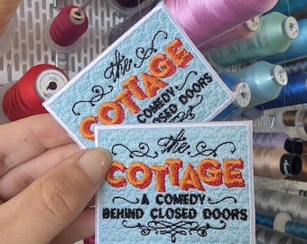 The Cottage, a comedy behind closed doors embroidered patch. Sew-on or iron-on. Custom design.