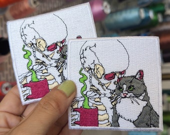 Skeleton and cat embroidered patch. To sew or iron on. Price per unit. Own design. 7.5cm.