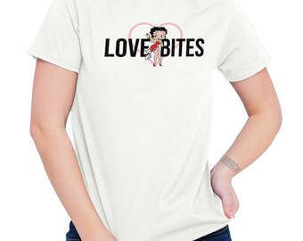 May include: White t-shirt with a pink heart and a cartoon image of Betty Boop. The text "LOVE BITES" is printed in black letters.