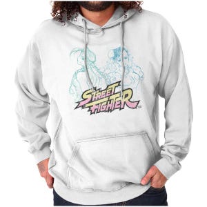 May include: White hoodie featuring a Street Fighter graphic. The design includes two characters and the text "Street Fighter" in a stylized font with yellow, pink, and blue accents. The hoodie has a front pocket and a drawstring hood.