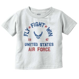 May include: A light gray t-shirt with the text "FLY FIGHT WIN" in a blue arch, with two red stars. Below, it reads "UNITED STATES AIR FORCE" in red and blue. The shirt also features the Air Force emblem.