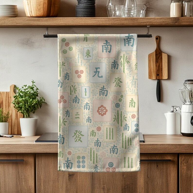 Mahjong tile pattern tea towel hanging on a kitchen rod with soft pastel colors