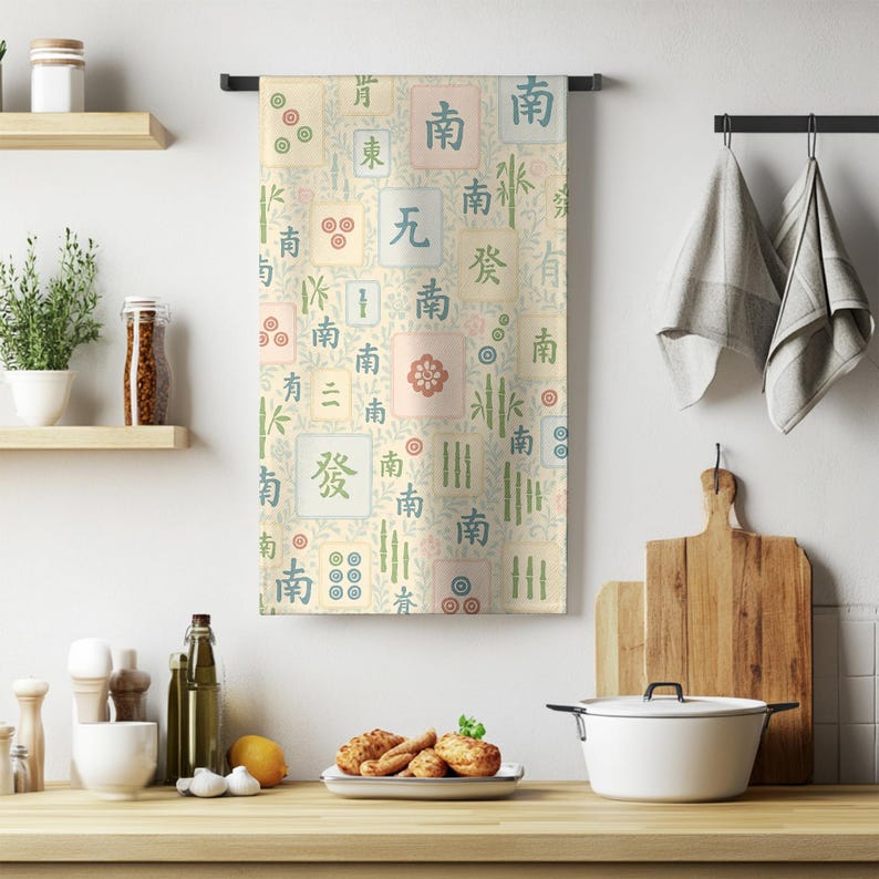 Mahjong tile kitchen towel with pastel illustrations hanging in a cozy kitchen