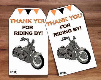 May include: Two white thank you tags with black and orange trim. The tags feature a black and white illustration of a motorcycle and the text "Thank You for Riding By!" with the words "From:" at the bottom.