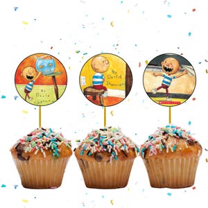 May include: Three cupcakes topped with colorful sprinkles and decorative toppers featuring illustrations from a children's book. The toppers are round with images of a young boy and the text "By David Shannon".