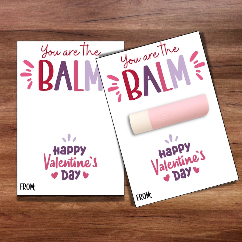 May include: Two Valentine's Day cards with the text "You are the BALM" and "Happy Valentine's Day". The card on the right has a pink lip balm attached.
