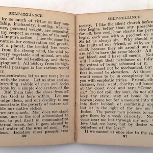 May include: Open book with text from "Self-Reliance" by Ralph Waldo Emerson. The pages are aged with text on both sides. The book is open to pages 30 and 31, with the title at the top of each page.