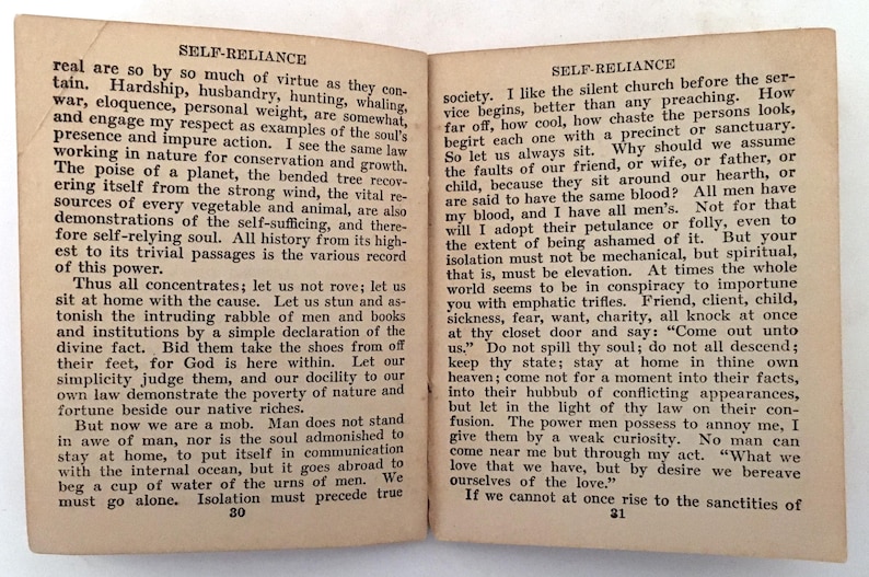 May include: Open book with text from "Self-Reliance" by Ralph Waldo Emerson. The pages are aged with text on both sides. The book is open to pages 30 and 31, with the title at the top of each page.