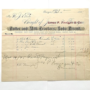 May include: An antique receipt from 1885, featuring handwritten text and a decorative banner. The receipt is for "Butter and Milk Crackers, Soda Biscuit" and lists various items and prices. The paper is aged with visible creases and stains.