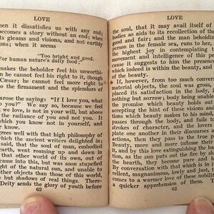 May include: Open book with aged, yellowed pages. The text discusses love and beauty, with the word "LOVE" at the top of each page. The book is open to pages 62 and 63, with text filling the pages.