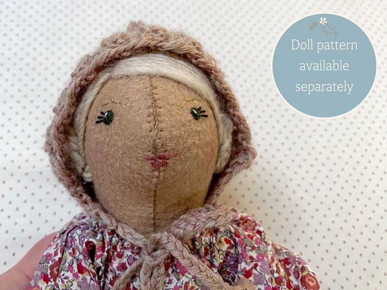 Handmade doll wearing handknit bonnet.