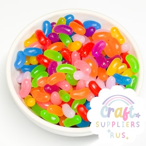 May include: A bowl filled with colorful jelly beans in various shades of red, orange, yellow, green, blue, and purple. The jelly beans are arranged in a random pattern, creating a vibrant and playful display.