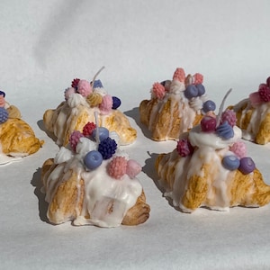 Cotton candy croissant “cream berry” with cream topping and small berries, unique dessert candle suitable for home decor and special gifting