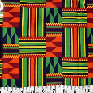May include: A colourful fabric with a geometric pattern in shades of red, orange, yellow, green, and blue. The fabric has a repeating pattern of stripes and squares. The fabric is labelled #2.