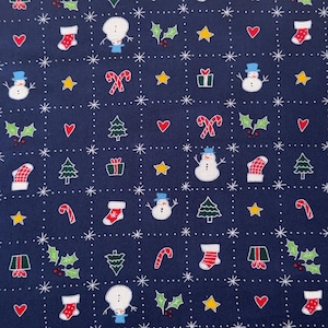 May include: A navy blue fabric with a repeating pattern of Christmas-themed illustrations. The pattern includes snowmen, candy canes, Christmas trees, holly, stars, and stockings.