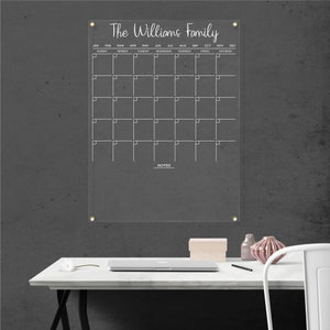 Personalized acrylic wall calendar with white detailing, featuring a monthly layout and a notes section.