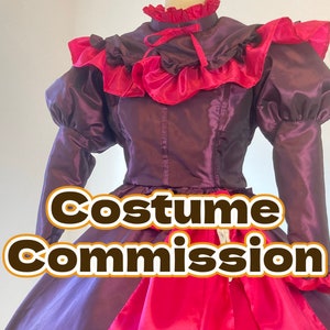 May include: A purple and red satin dress with a ruffled collar and sleeves. The dress has a fitted bodice and a full skirt. The text "Costume Commission" is printed on the front of the dress.
