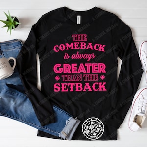 May include: Black long-sleeve shirt with pink text that reads "The Comeback is always Greater Than The Setback".