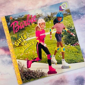 May include: A Golden Books Barbie book titled "Girls on Blades" featuring two Barbie dolls rollerblading. One doll is wearing a pink helmet, pink shirt, black pants, and pink rollerblades. The other doll is wearing a blue helmet, red and white striped shirt, blue jean shorts, and white rollerblades. The book cover has a yellow background with a pattern of hearts.