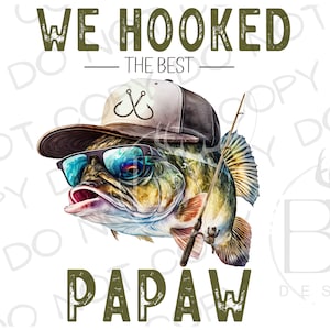 May include: A green and white illustration of a fish wearing a baseball cap, sunglasses, and holding a fishing rod. The text "We Hooked The Best Papaw" is written in green.