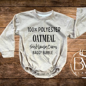 May include: A long-sleeved, light beige baby onesie with the text "100% POLYESTER OATMEAL sublimation BAGGY BUBBLE" printed on the front. The onesie is made by BW Blanks.
