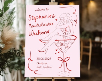 Könnte beinhalten: Rosa Willkommens-Schild mit rotem Text und einer Strichzeichnung einer Frau, die in einem Martini-Glas sitzt. Der Text lautet "Willkommen zu Stephanie's Bachelorette Weekend 30.06.2024 Charleston, South Carolina".