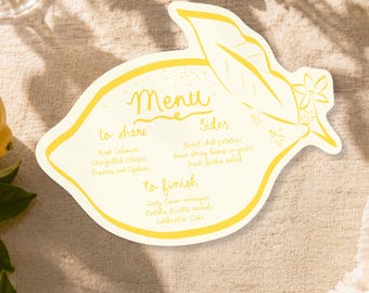 Puede incluir: Una tarjeta de menú con forma de limón, fondo amarillo pálido y contornos en amarillo brillante. El texto dice Menu, to share, Fried Calamari, Chargrilled Octopus, Prawns and Oysters, Sides, Roast chat potatoes, green string beans in garlic, Fresh Garden salad, to finish, Zesty lemon meringue, Nutella Ricotta cannoli, Celebration Cake.