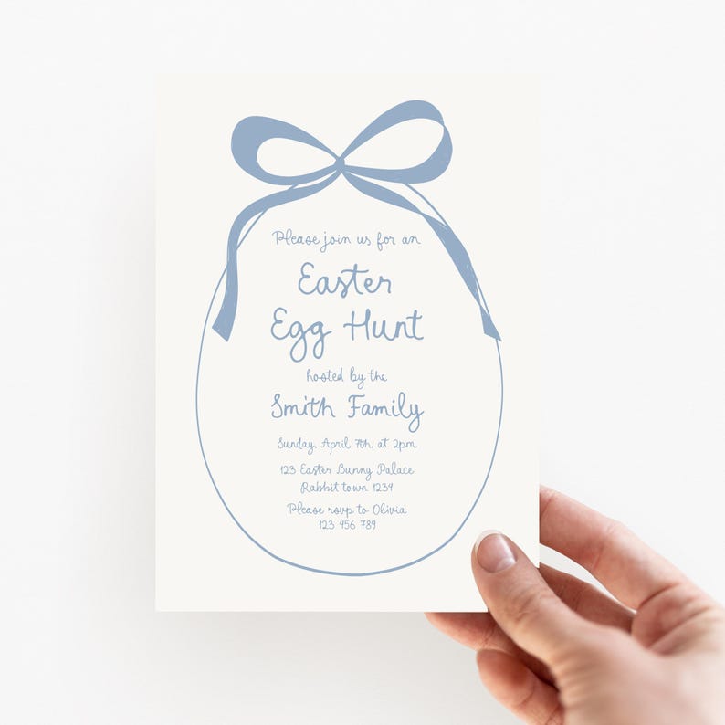May include: Blue and white invitation for an Easter egg hunt hosted by the Smith Family. The invitation features a blue ribbon tied around an egg shape. The text reads: "Please join us for an Easter Egg Hunt hosted by the Smith Family. Sunday April 7th at 2pm. 123 Easter Bunny Palace. Rabbit town 1234. Please RSVP to Olivia. 123 456 789."