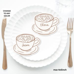 May include: Two coffee cup-shaped place cards with heart latte art, each on a saucer, sit on a white plate. One says "Olivia" and the other says "Jason". The text "CHANGE TO ANY COLOR" and "max 4x5inch" are also visible.