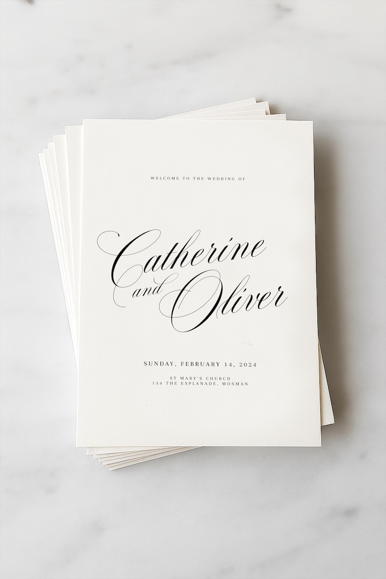 May include: A stack of white rectangular wedding programs with black text. The text reads: WELCOME TO THE WEDDING OF, Catherine and Oliver, SUNDAY, FEBRUARY 14, 2024, ST MARY'S CHURCH, 134 THE ESPLANADE, MOSMAN. The names are in a large, elegant script font.