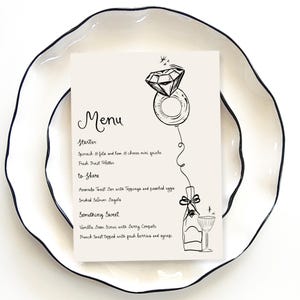 May include: A black and white menu with a hand-drawn illustration of a diamond ring on a balloon. The menu lists starter, to share, and something sweet options. The text reads: "Menu, Starter, Spinach & feta and ham & cheese mini quiche, Fresh Fruit Platter, to Share, Avocado Toast Bar with Toppings and poached eggs, Smoked Salmon Bagels, Something Sweet, Vanilla Bean Scones with Berry Compote, French toast topped with fresh berries and syrup."