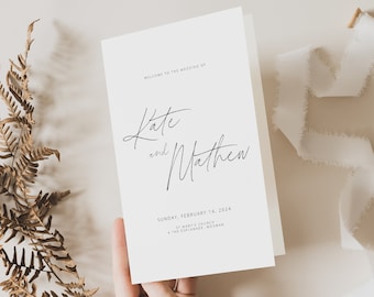May include: Wedding invitation card with a white background and black text. The text reads "Welcome to the wedding of Kate and Matthew" and "Sunday, February 14, 2024, St Mary's Church, 4 The Esplanade, Mosman".
