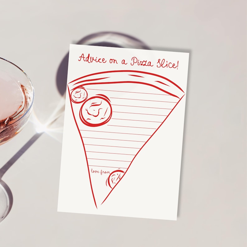 May include: A white card with a red pizza slice design and the text "Advice on a Pizza Slice!". The card has a lined interior for writing and the words "love from" at the bottom. A glass of pink liquid is in the background.