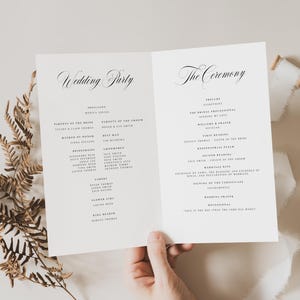 May include: A white folded wedding program card featuring black serif and script typography. The left panel is titled Wedding Party and the right panel is titled The Ceremony, listing various roles and names in a clean, minimalist layout.