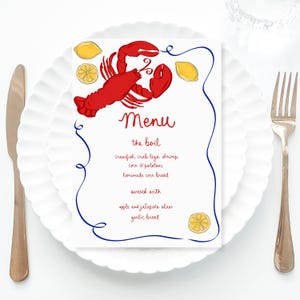Könnte beinhalten: Eine weiße Speisekarte mit einer Illustration eines roten Hummers und gelben Zitronen. Die Speisekarte lautet "Menü, das Kochen, Krebse, Krabbenbeine, Garnelen, Mais & Kartoffeln, hausgemachtes Maisbrot, serviert mit, Apfel- und Jalapeño-Salat, Knoblauchbrot."