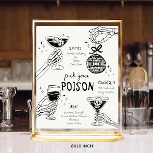 May include: A black and white printable sign with a spooky Halloween theme. The sign features a skeleton hand holding a martini glass with a skull inside. The text on the sign reads "pick your poison" and lists various spirits, cocktails, and beers.