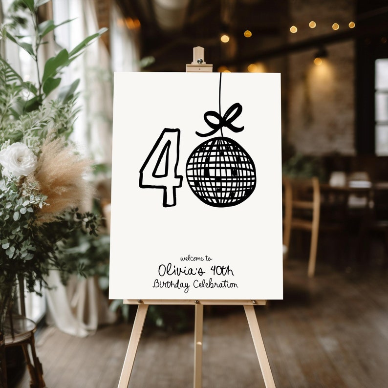 Op de afbeelding: Een wit bord met zwarte tekst en een zwart-witte discobal-illustratie. Het bord luidt "Welkom op Olivia's 40e verjaardag".