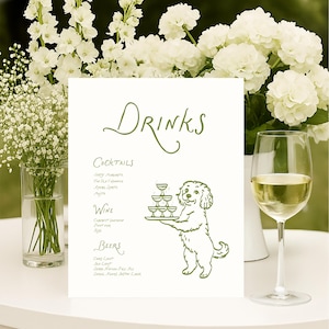 Może przedstawiać: Biały znak z napisem "DRINKS" w zielonym skrypcie, wymieniający koktajle, wino i piwa. Kreskówkowy pies trzyma tacę z kieliszkami. Obecne są również białe kwiaty i kieliszek wina.