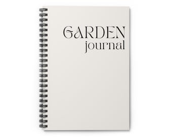 May include: A white spiral bound journal with the text "GARDEN journal" printed in black.